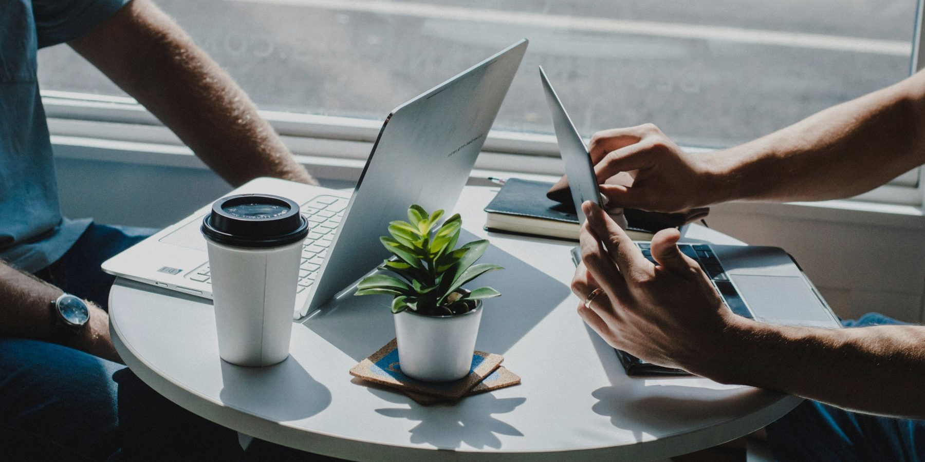 Laptops and a tablet in a business setting, representing website and material readability